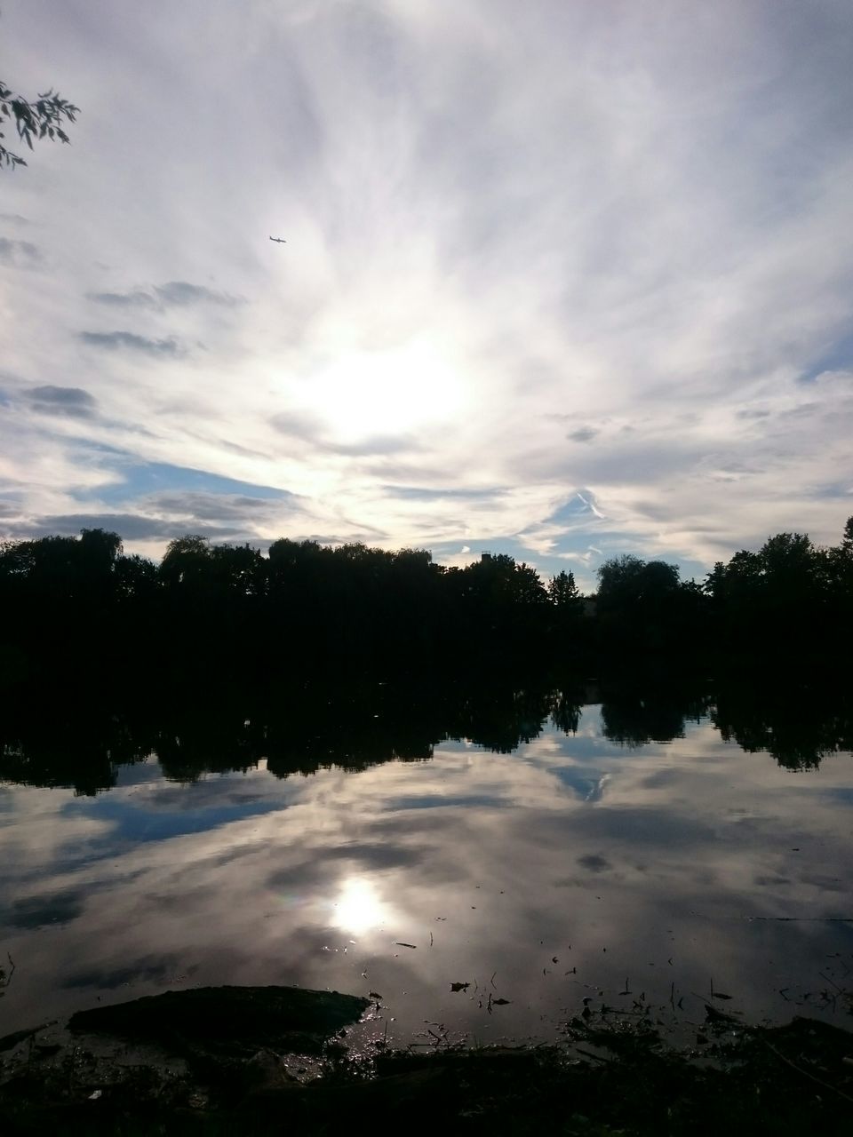 tranquil scene, tranquility, lake, scenics, beauty in nature, water, tree, calm, sky, reflection, nature, cloud - sky, idyllic, cloud, non-urban scene, cloudy, mountain, majestic, waterfront, remote, outdoors, sunbeam, countryside, no people, solitude, mountain range