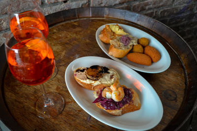 Close-up of red wine and snacks on table