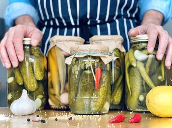 Artisanal man doing pickles jars stock for winter season organic homemade pickles pickling cucumbers