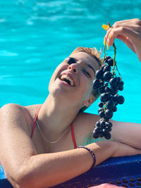 Portrait of woman with swimming pool