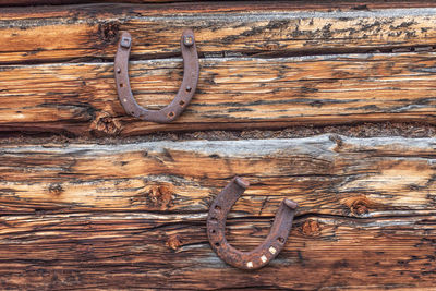 Full frame shot of wood with horse shoe