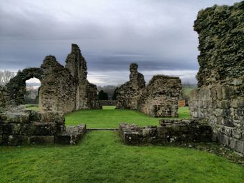 Ruins of temple against cloudy sky