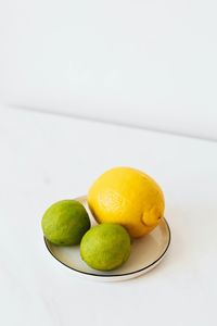 Close-up of lemons on white background
