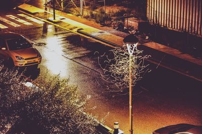 High angle view of cars on street by canal