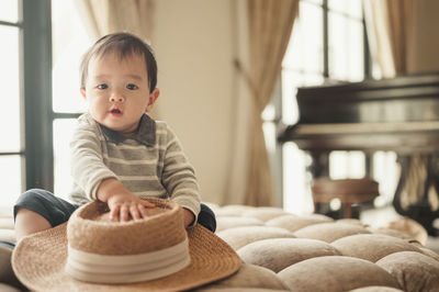 Portrait of cute girl sitting at home