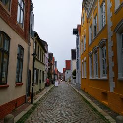 Street amidst buildings against sky