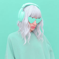 Woman wearing headphones against blue background