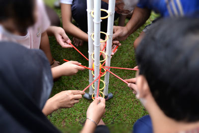 Rear view of people holding hands as a teamwork