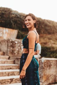 Portrait of a smiling young woman standing outdoors