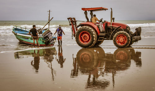 People in boat on sea against sky