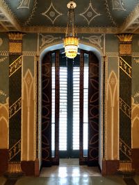 Close-up of illuminated lamp hanging on ceiling of building