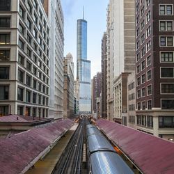 Railway station amidst towers in city