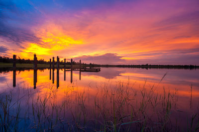 Scenic view of lake against orange sky