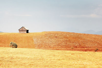 Built structure on field against sky