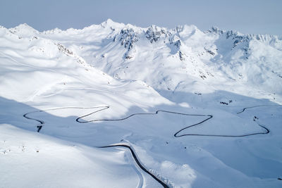 Snow covered landscape against sky