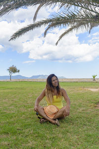 Portrait of a latin woman smiling, vacation in mallorca under a palm tree, hollidays concept