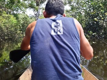 Rear view of man standing by tree