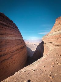 Scenic view of rocky mountains against clear blue sky