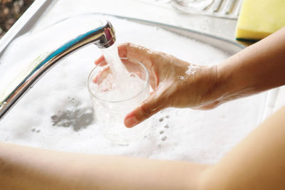 Midsection of woman preparing food in water