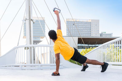 Low section of man exercising on beach