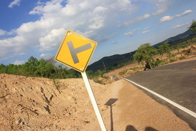 Road sign against sky