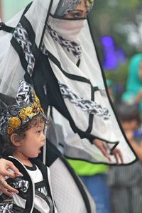 Young woman with son wearing costume during event