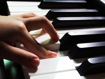 Close-up of hands playing piano