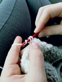 Midsection of woman crocheting wool