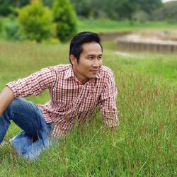 Man sitting on grassy field