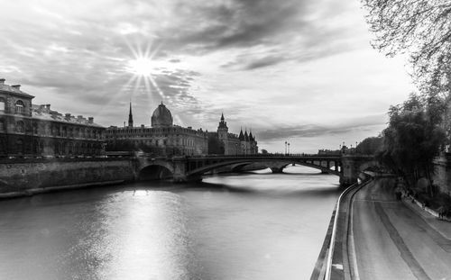 View of bridge over river against cloudy sky