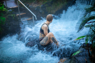 Woman in waterfall