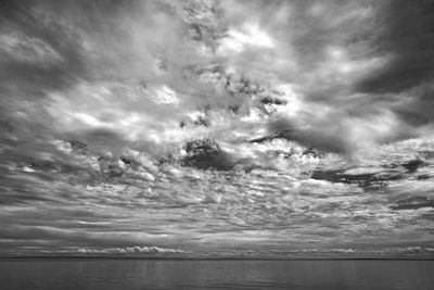 Scenic view of sea against cloudy sky