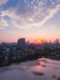 Scenic view of buildings against sky during sunset