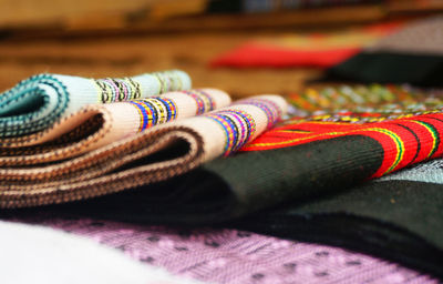 Close-up of multi colored folded textiles on table