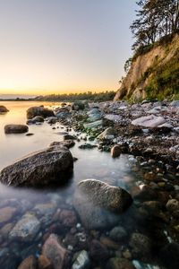 Scenic view of sea against clear sky at sunset