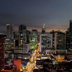 High angle view of illuminated buildings against sky at night