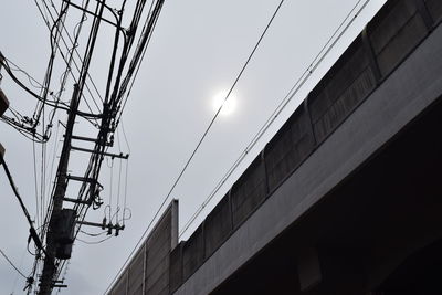 Low angle view of electricity pylon against sky