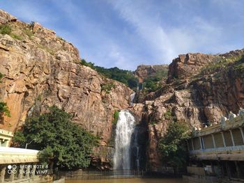 Scenic view of waterfall against sky