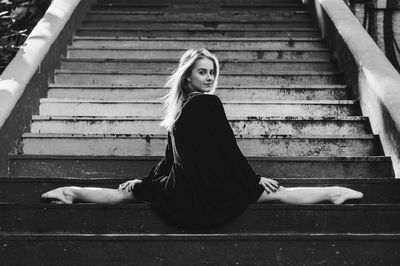 Portrait of woman sitting on staircase