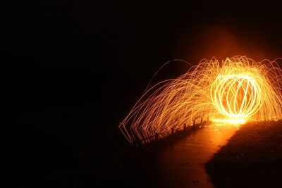 Close-up of illuminated fireworks against clear sky at night