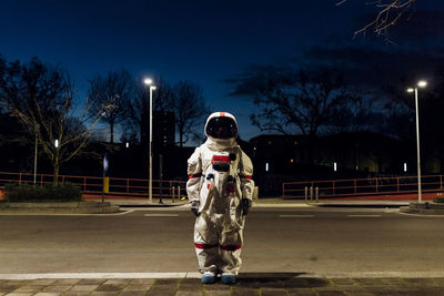 Full length of a person standing on road at night