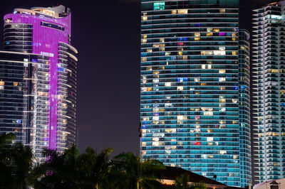 Low angle view of modern buildings in city at night