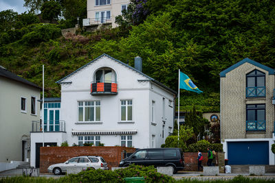 Houses by building in city