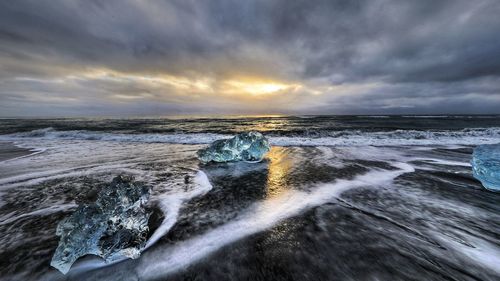 Scenic view of sea against dramatic sky