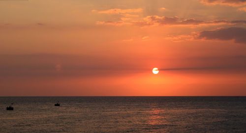 Scenic view of sea against orange sky