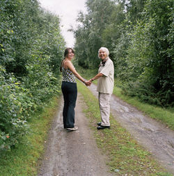 Young and senior women standing on dirt track