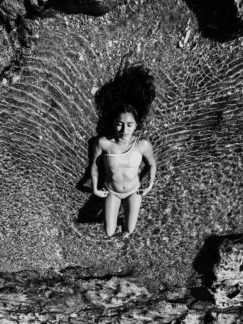 High angle view of teenage girl lying at beach