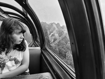 Portrait of young woman sitting in car