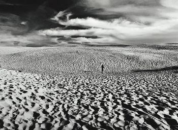 Surface level of sandy beach against sky