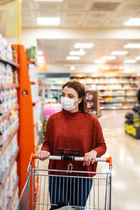 Woman wearing mask shopping at mall